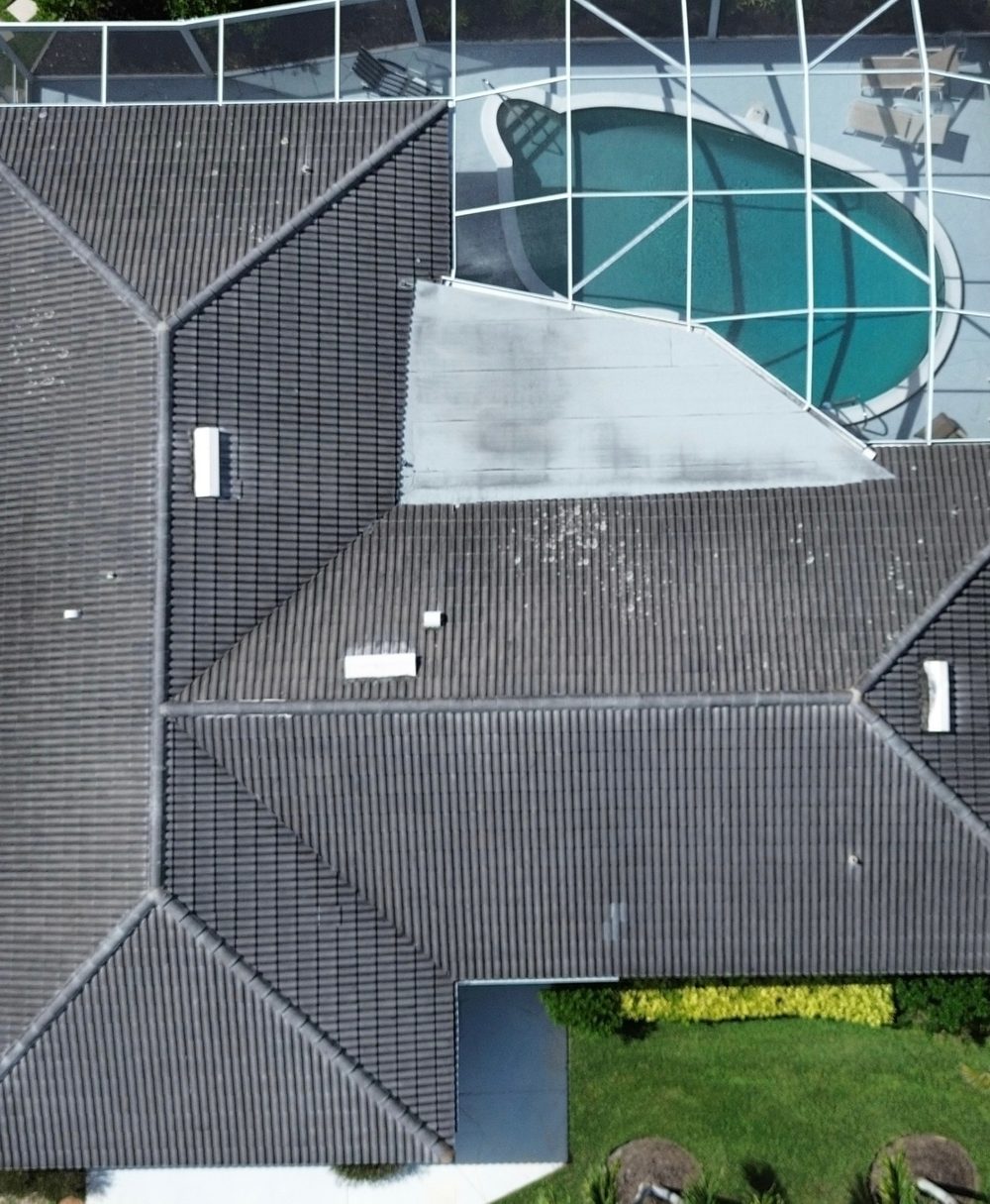 Roof before cleaning, showing algae and dark streaking